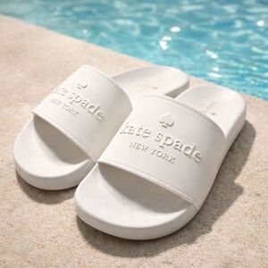 Cute KATE SPADE slides - Size 7  Logo on wamp Color : Off white New without box.